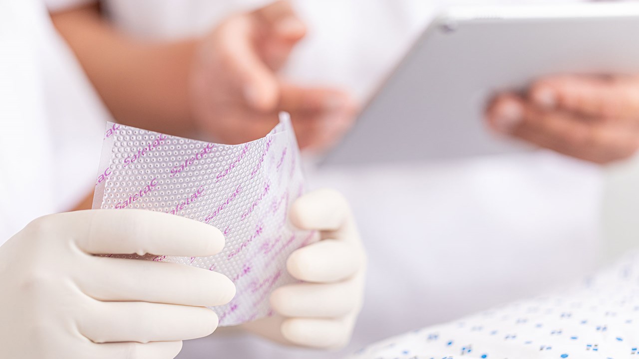 A hand applying Safetac product on skin